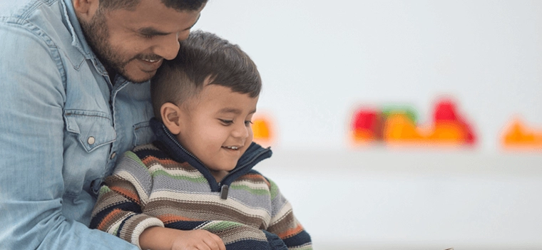father and son smilling