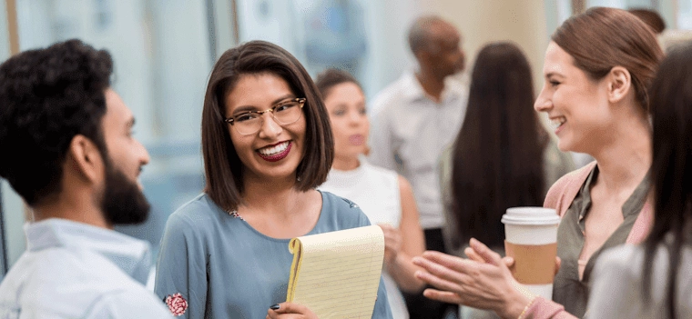 three people meeting and smiling